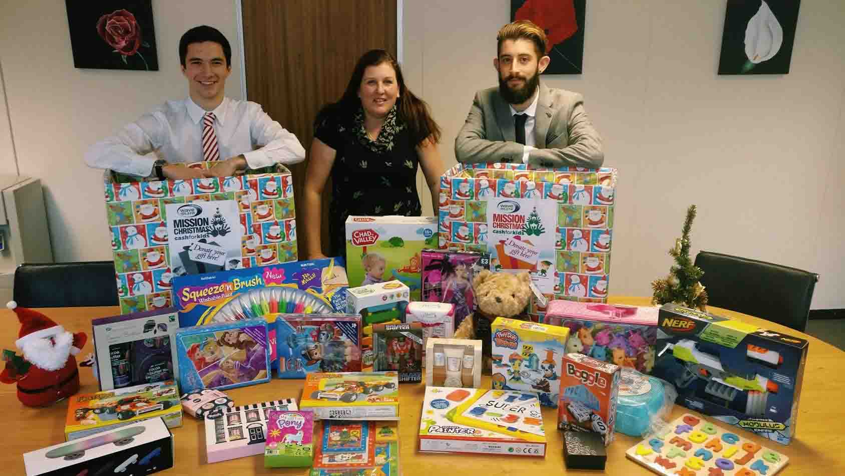 Wessex employees alongside a pile of presents donated by employees from all around the company